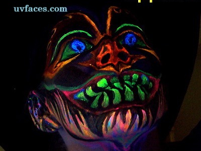 UV clown glowing under blacklight with neon paint