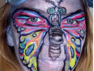 UV neon butterfly face painting glowing under blacklight